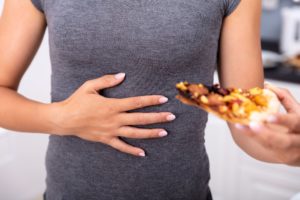 Acid reflux prevention tips include avoiding high-fat foods, tomatoes, onions, and garlic, as well as not overeating.